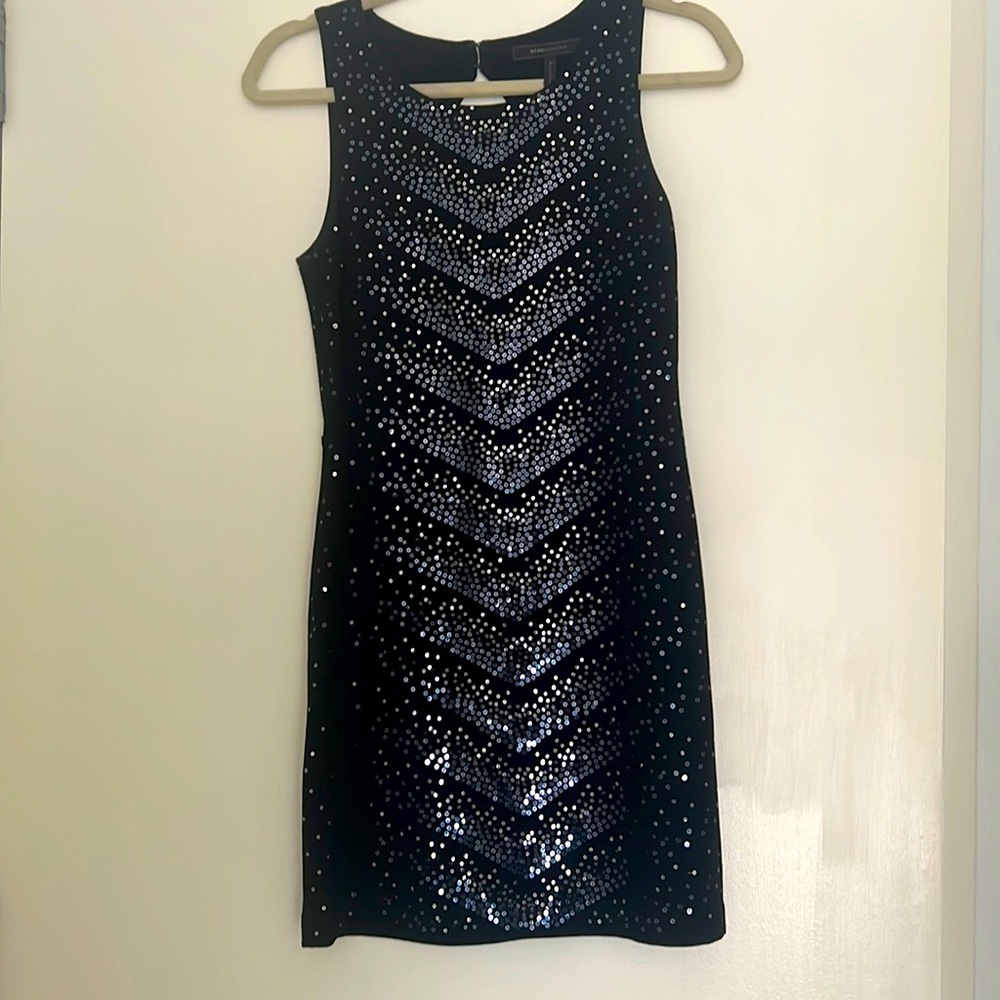 Mini black, sleeveless, sequin-detail dress. Open back.